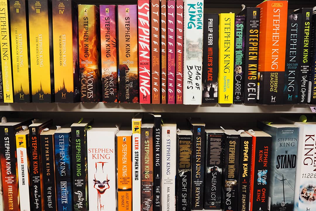Stephen King's novels arranged in a shelf from a bookstore.  